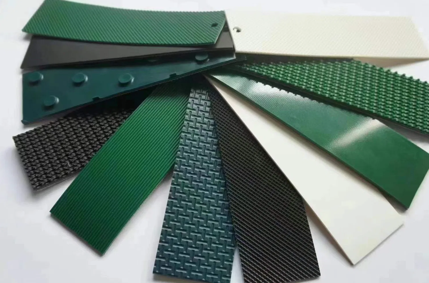 Fan sample swatches of PVC and PU conveyor belt surface patterns and textures by Nova Beltech