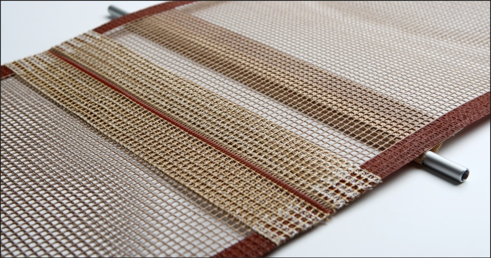 Heat-resistant PTFE coated open mesh conveyor belt with Kevlar edge reinforcement and pin splice joint by Nova Beltech