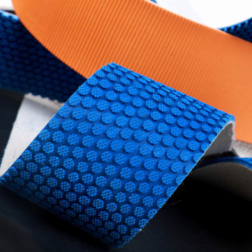 High-grip blue studded and orange ribbed rubber conveyor belt surfaces for high-traction conveying by Nova Beltech