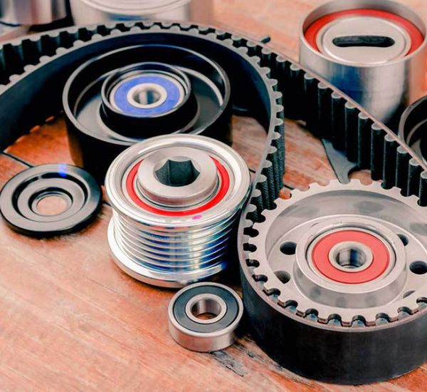 Heavy-duty rubber timing belt with drive pulleys and tensioner bearings by Nova Beltech