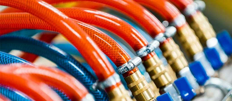Reinforced industrial hoses connected to brass quick disconnect couplings and manifold valves by Nova Beltech