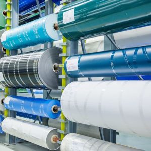 Warehouse storage racks filled with large industrial PVC and PU conveyor belt master rolls at Nova Beltech